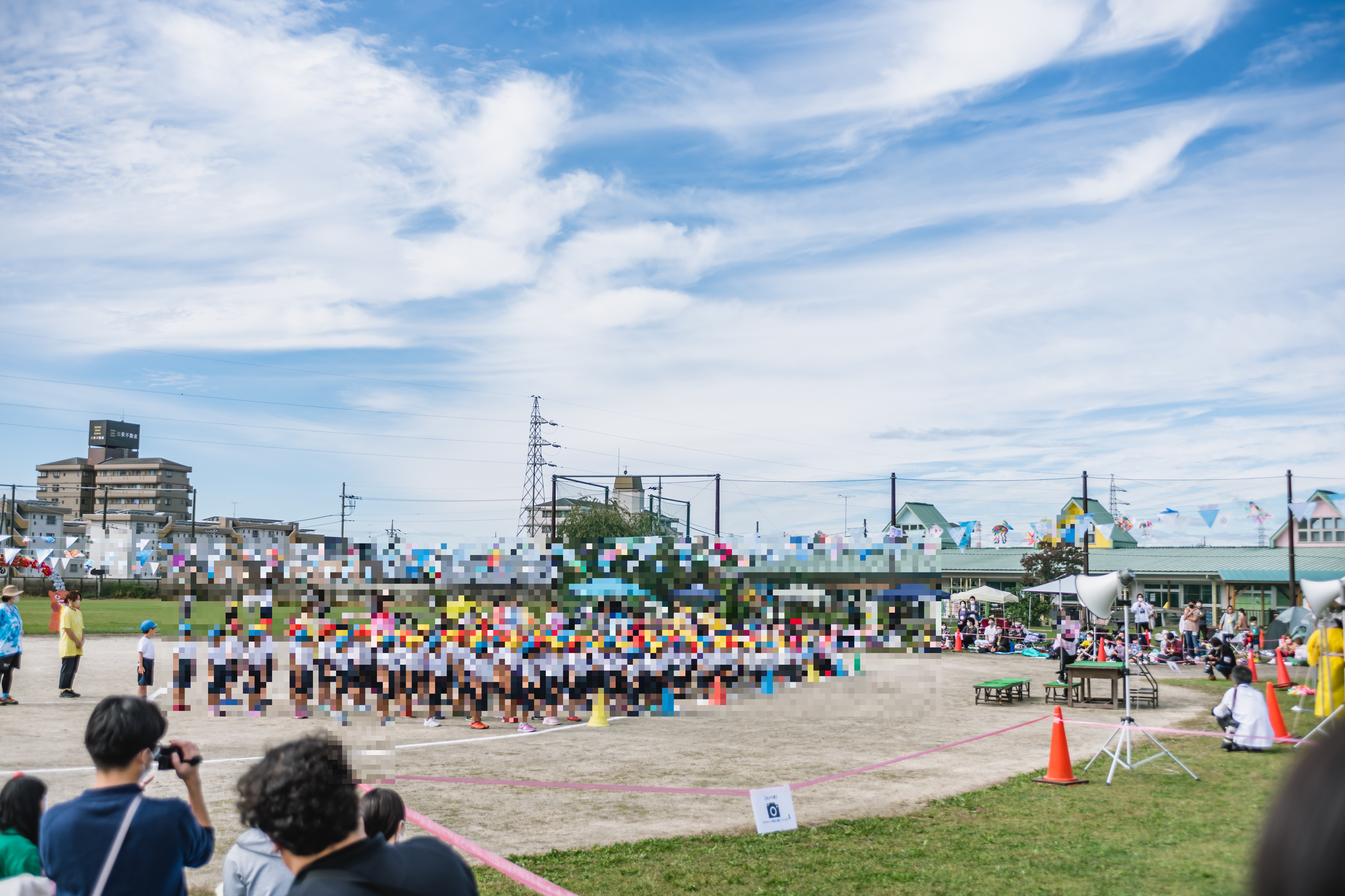 園庭で整列する園児たちと青空